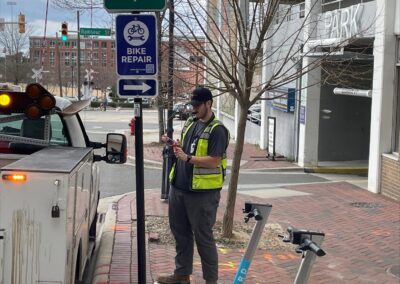 A man standing next to a street sign.