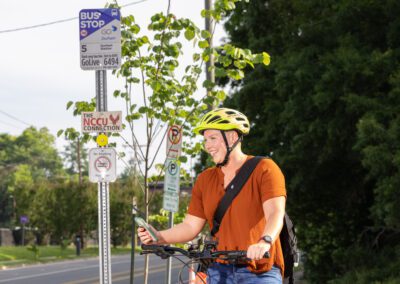 A man on his bike looking at the phone