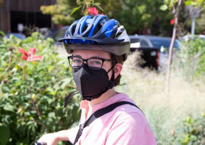 A man wearing a helmet and glasses while riding his bike.