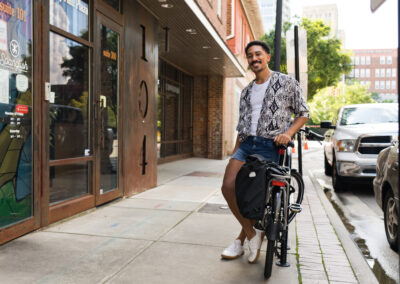 A man sitting on the side of a bike.