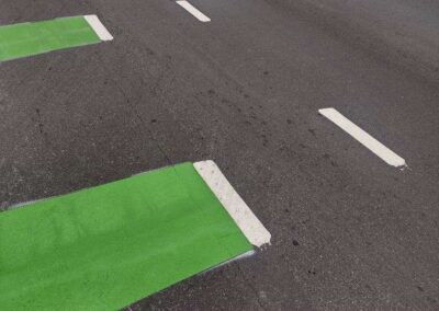 A street with green lines painted on it.