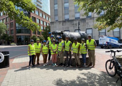 A group of people standing next to a statue.