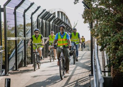 A group of people riding bikes on the side of a road.